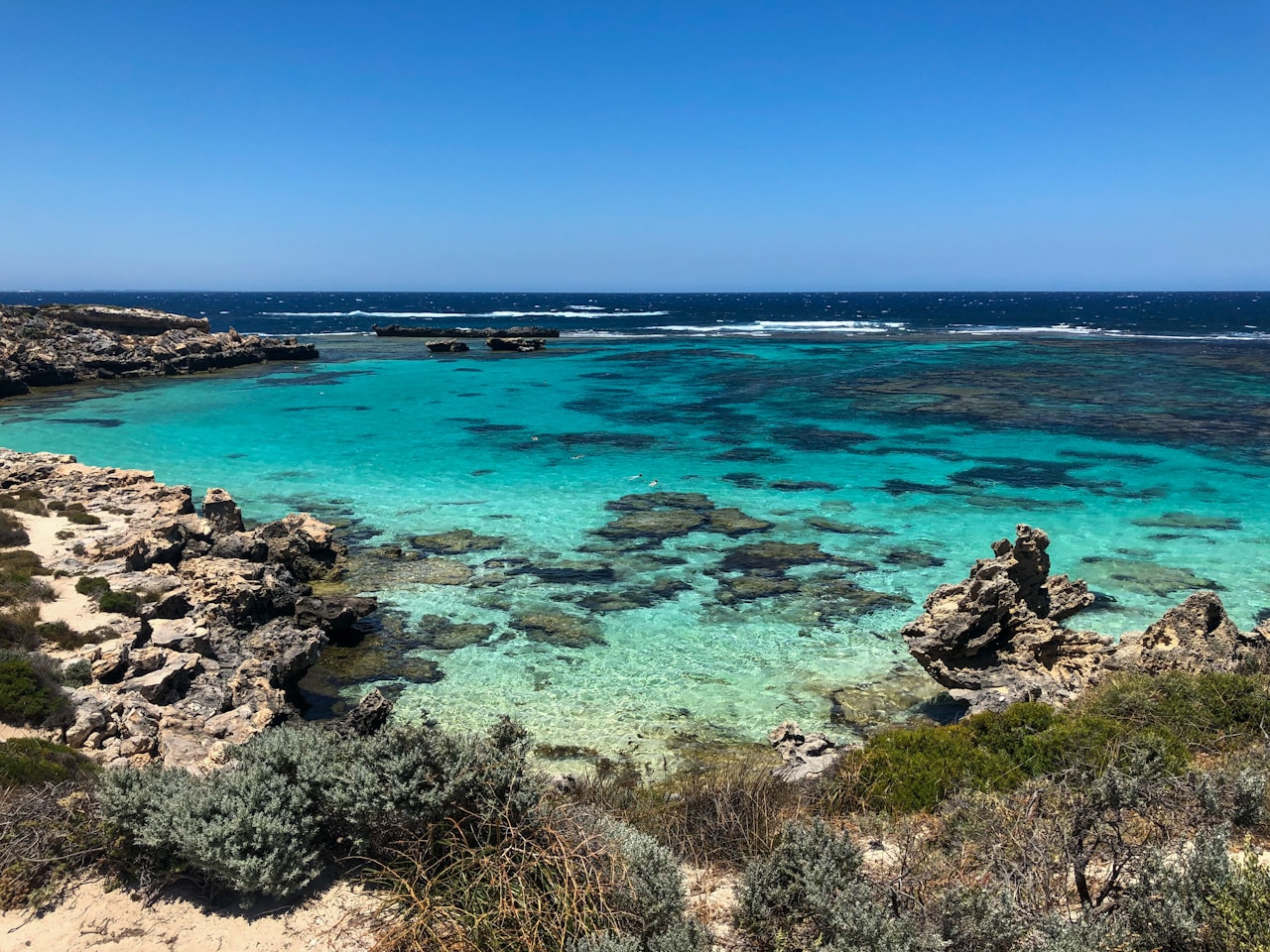 Aerial view of Rottnest Island bay with boats and white sand beach